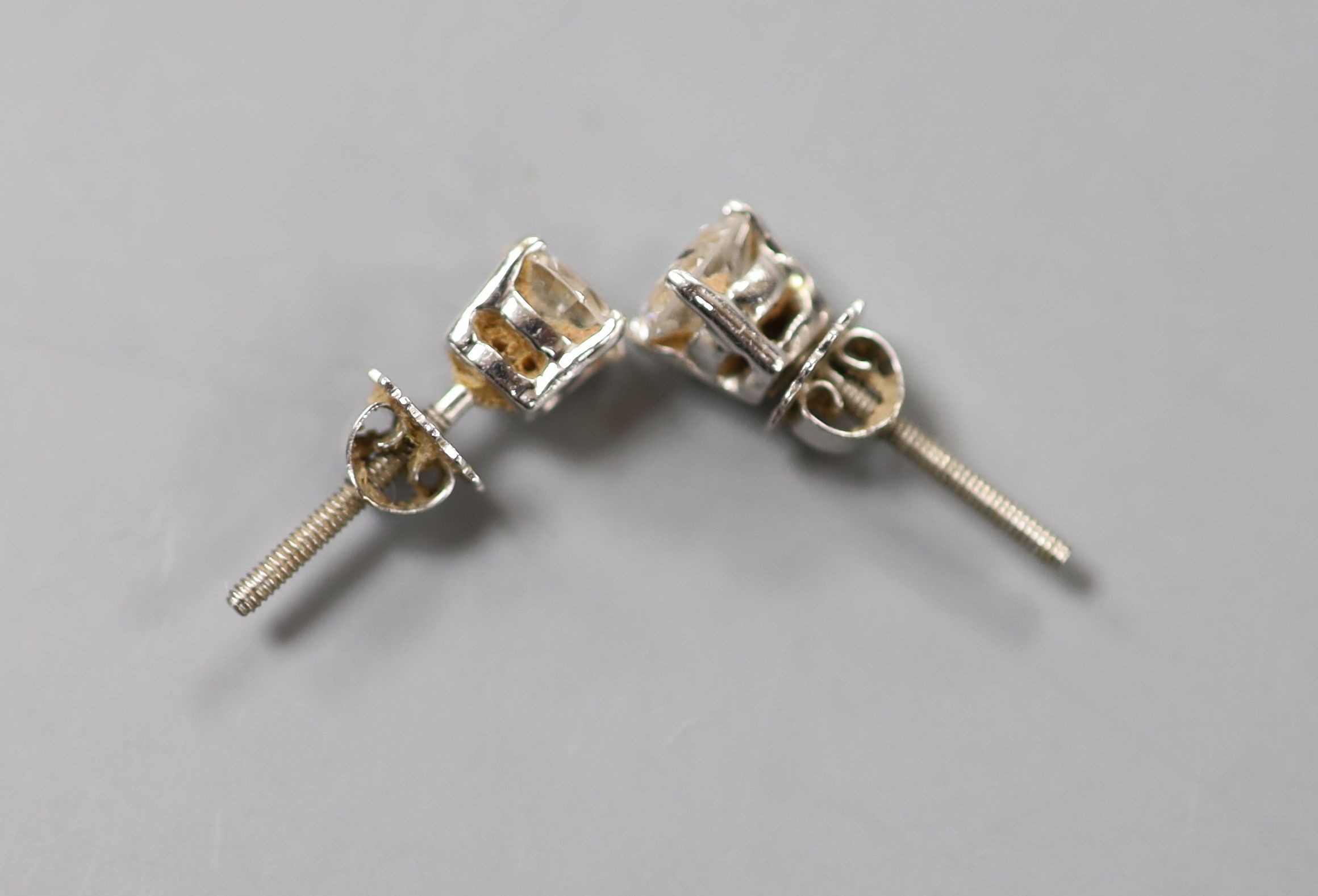 A pair of 18ct white metal and solitaire diamond ear studs, with a total diamond weight of approximately 1.50ct, gross weight 2 grams